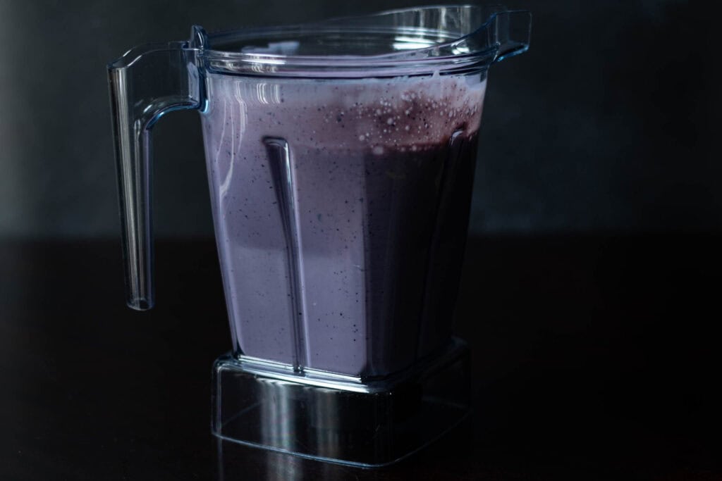 A blueberry dragonfruit smoothie in a blender.