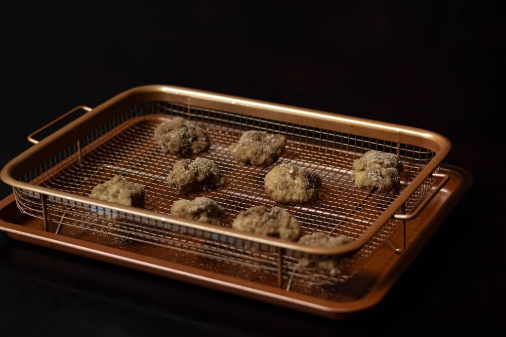 High Protein Cinnamon Sugar Donut Holes on a copper crisping tray.