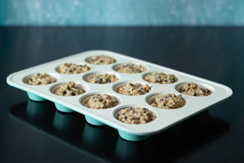 Banana Nut Muffin Batter in muffin tin, uncooked.