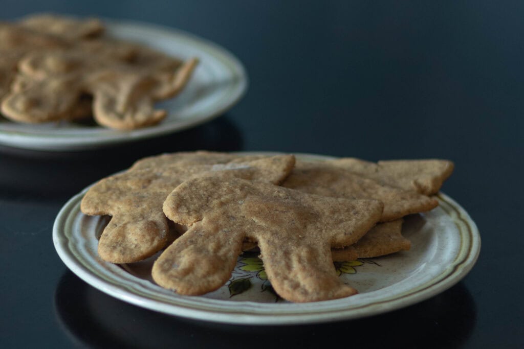 Small plate with a few peanut butter cookies shaped like the Pi symbol.
