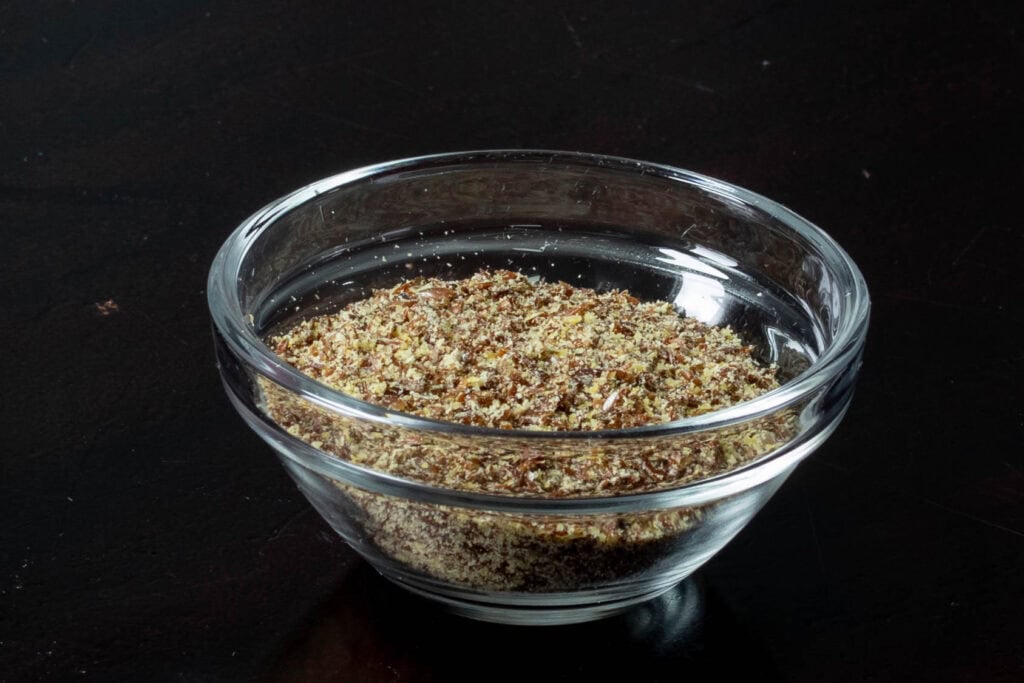 Ground flax seed in a small glass bowl.