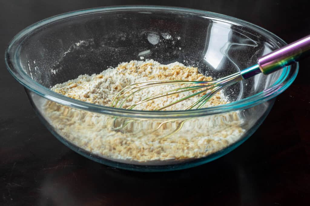 Mixed dry ingredients for pumpkin pecan muffins.