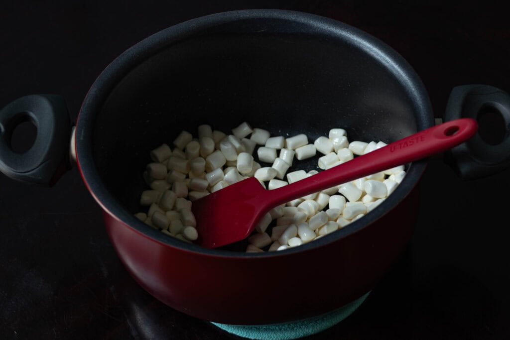 Mini marshmallows in large pot coated with melted butter.