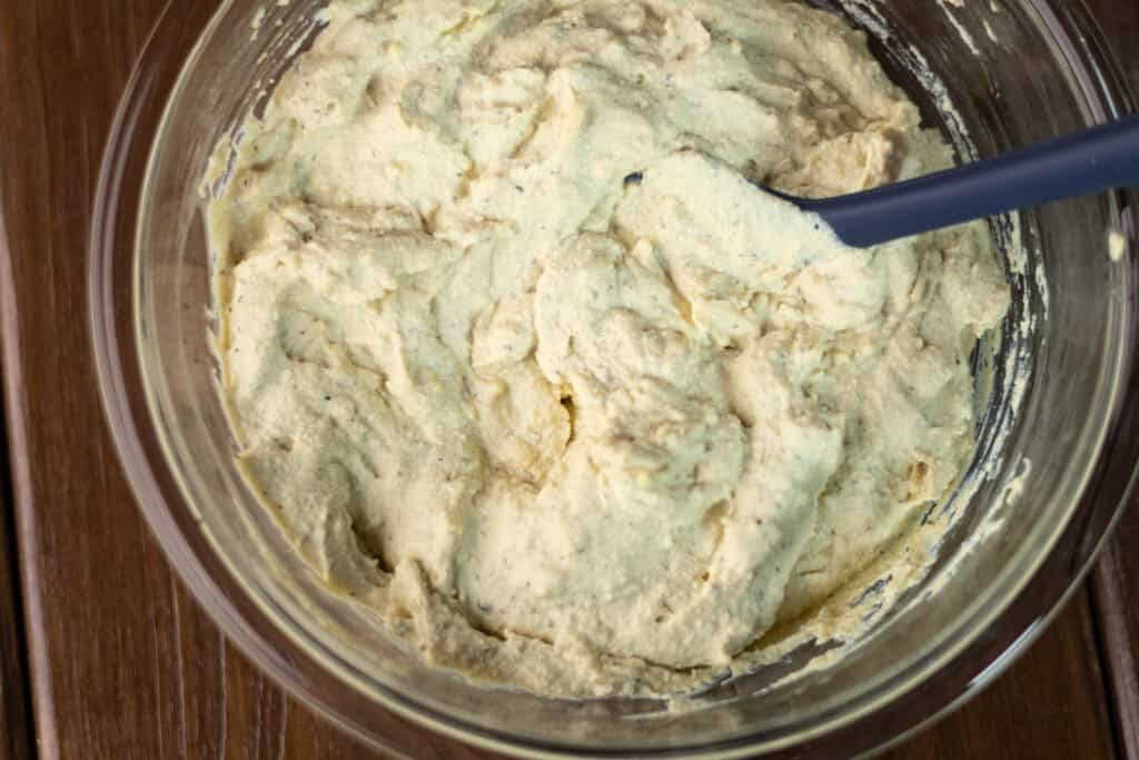 Ricotta filling for the lasagna in a glass bowl.