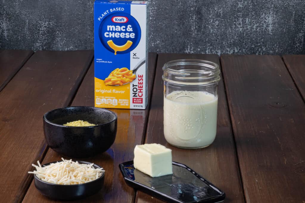 Doctored vegan mac and cheese ingredients - Kraft plant-based mac and cheese, nutritional yeast, soy milk, vegan parmesan, and butter.