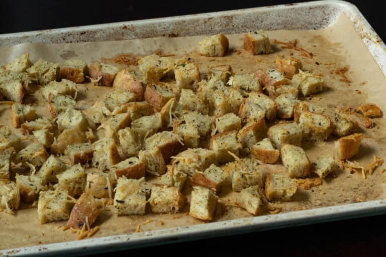 High protein croutons on a parchment paper lined baking sheet.