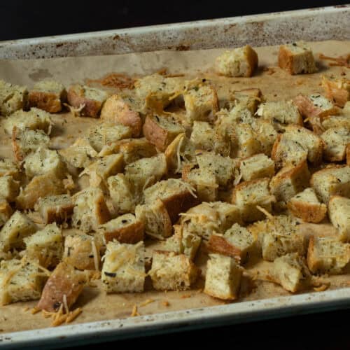 High protein croutons on a parchment paper lined baking sheet.