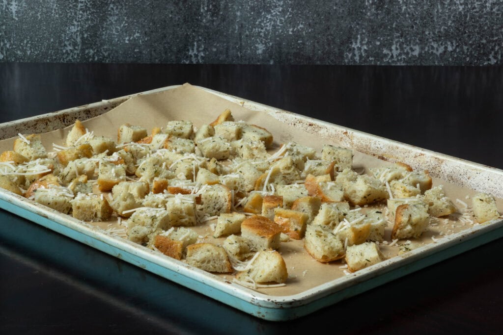 High protein croutons on a parchment paper lined baking sheet, not cooked yet.