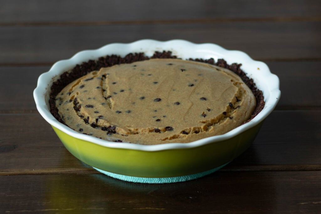 Peanut butter chocolate chip cheesecake in a deep dish pie pan.
