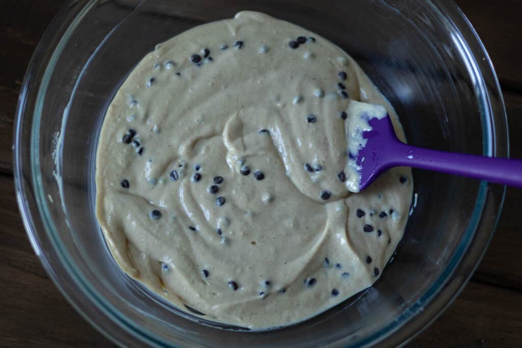 Large glass bowl with peanut butter chocolate chip cheesecake filling.