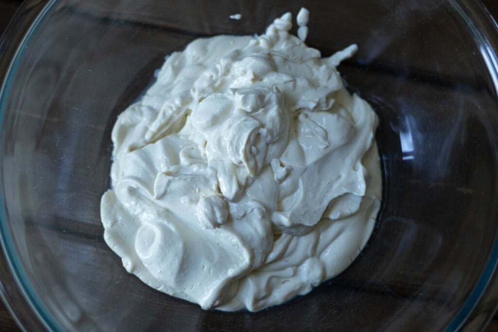 Blended silken tofu in a large glass bowl.