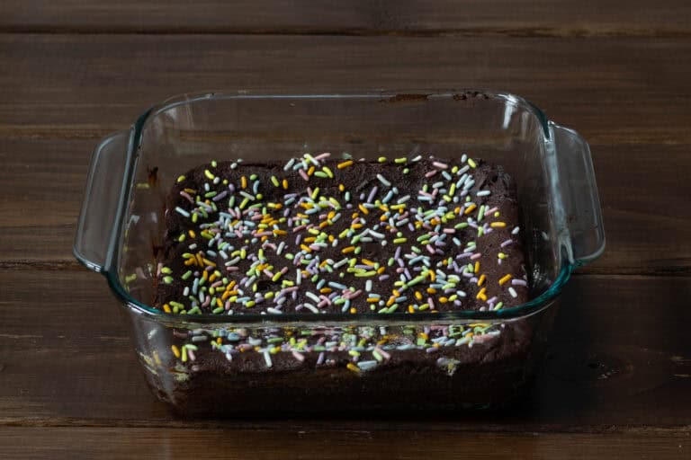 Protein brownies in a square glass container.