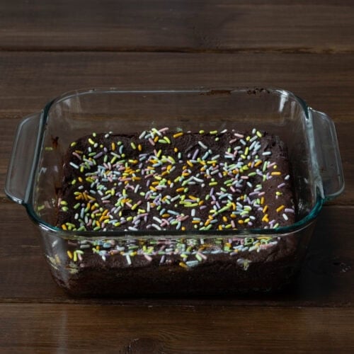 Protein brownies in a square glass container.
