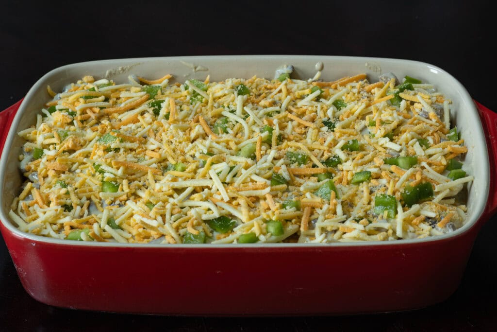 Large casserole dish with uncooked scalloped potatoes.