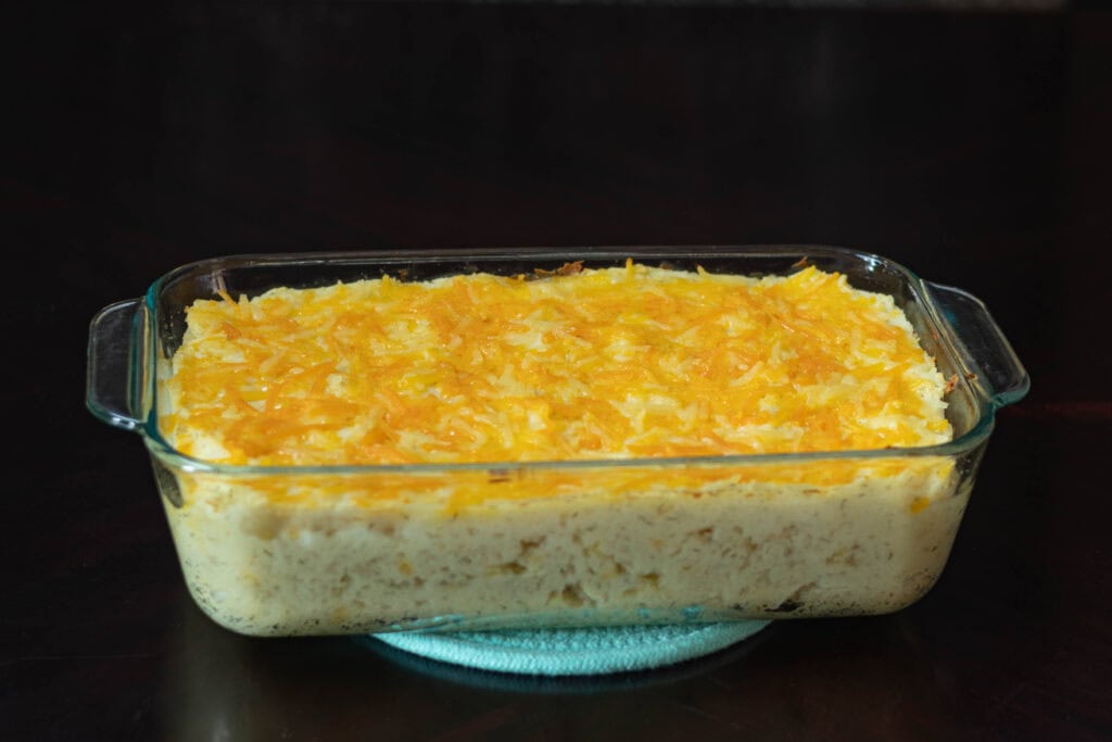 Cooked twice baked potato casserole with melted vegan cheese.