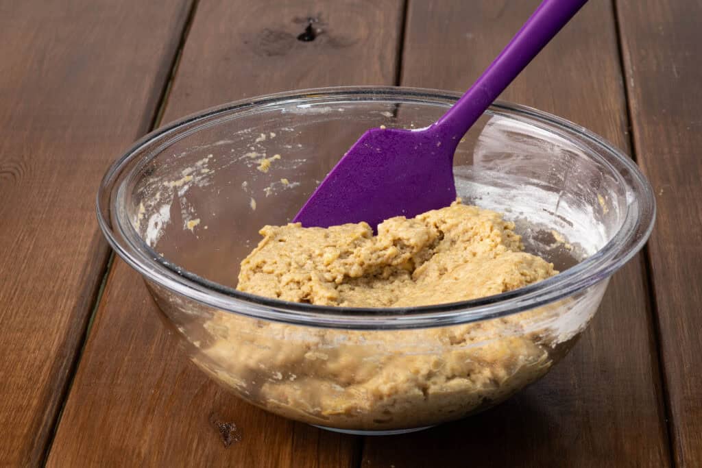 Banana bread seitan dough in a glass bowl.