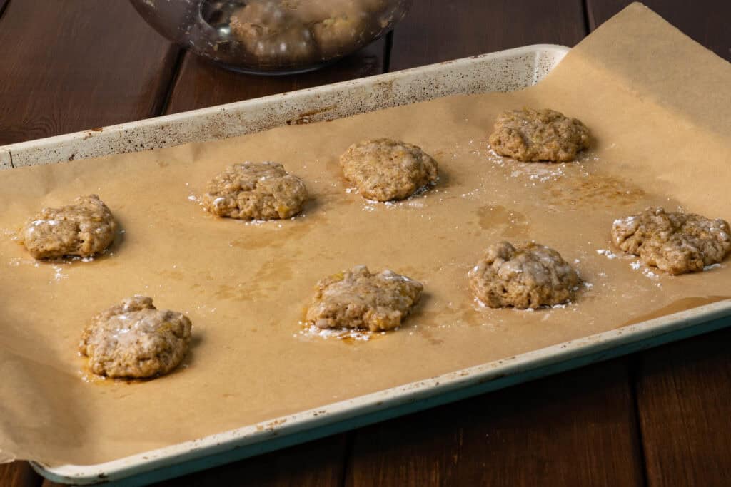 Uncooked banana bread seitan cookies on a baking tray.
