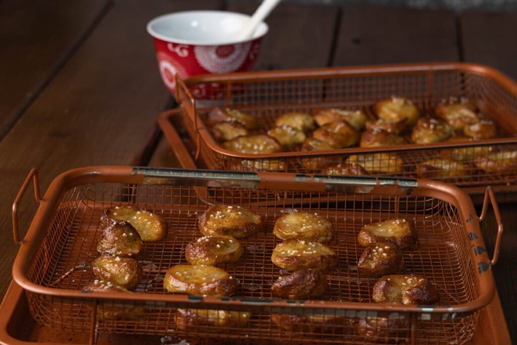 Pretzel bites on a copper crisping trays.