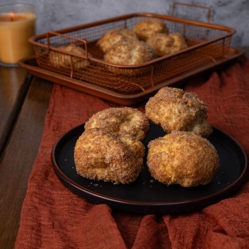 High Protein Pumpkin Spice Balls sitting on a plate with a crisping tray in the background.
