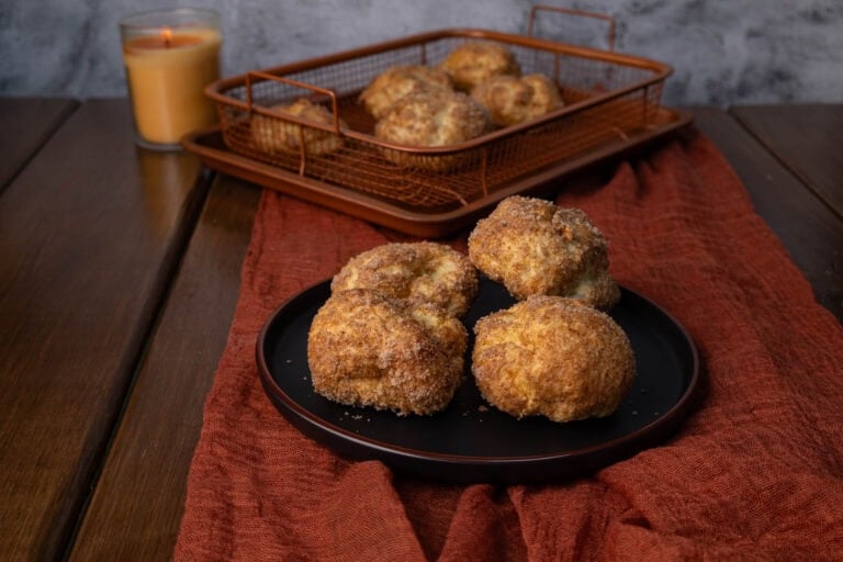 High Protein Pumpkin Spice Balls sitting on a plate with a crisping tray in the background.