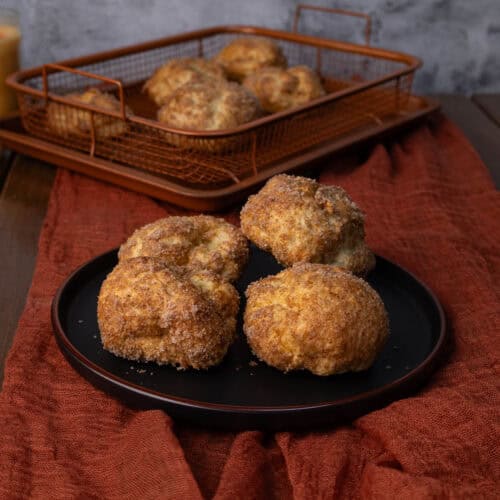 High Protein Pumpkin Spice Balls sitting on a plate with a crisping tray in the background.