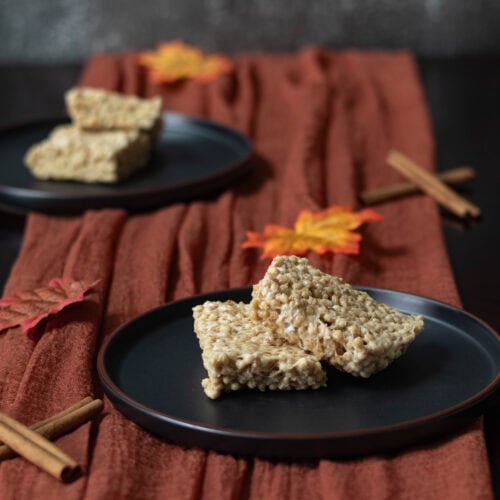 High Protein pumpkin spice "rice" crispy treats on a fall decorated table.