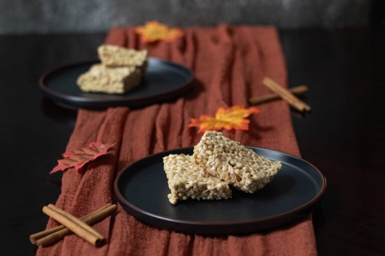 High Protein pumpkin spice "rice" crispy treats on a fall decorated table.