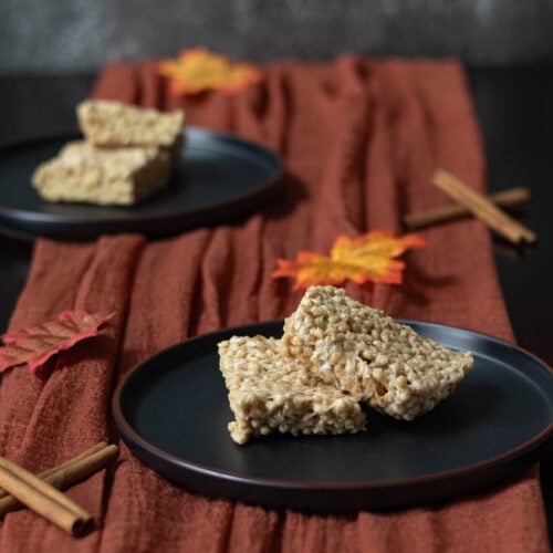 High Protein pumpkin spice "rice" crispy treats on a fall decorated table.