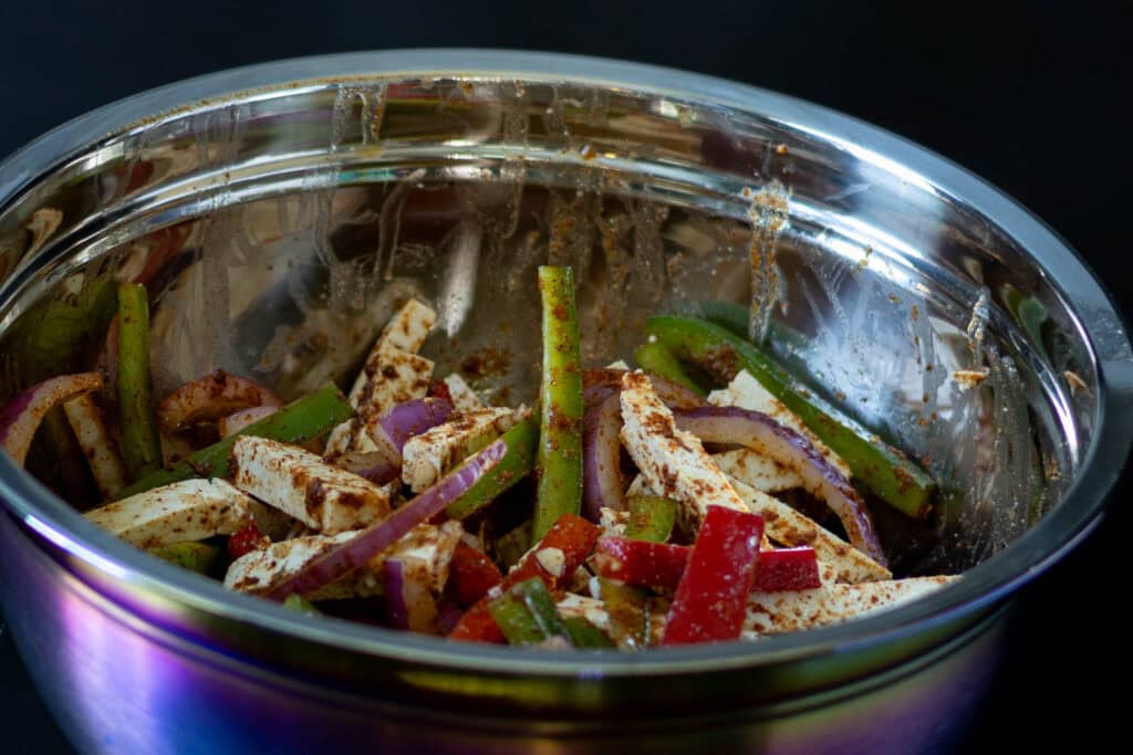 Seasoned tofu fajita ingredients in a bowl.