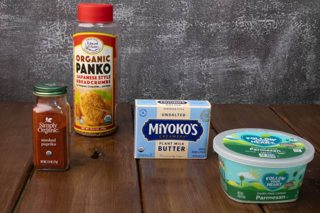 Ingredients for the mac and cheese breadcrumbs - smoked paprika, panko, vegan parmesan, and vegan butter.
