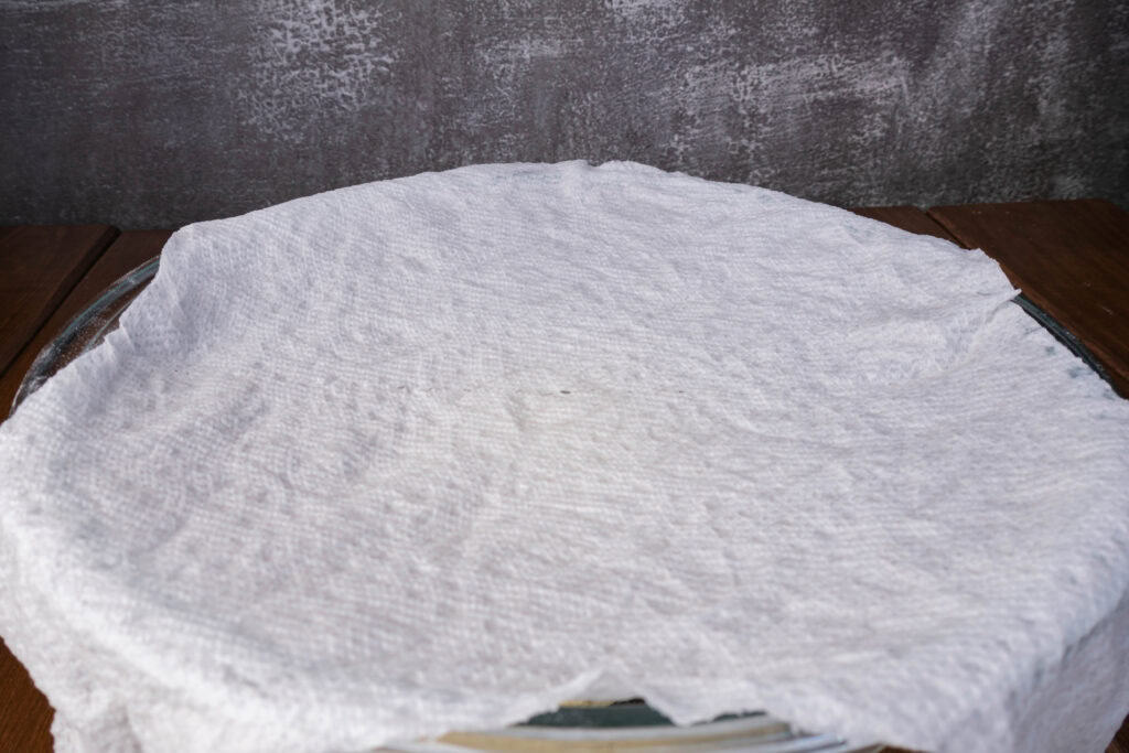 Dough covered with wet paper towel.