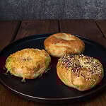 Plate with three high protein bagels - toasted parmesan, everything and plain.