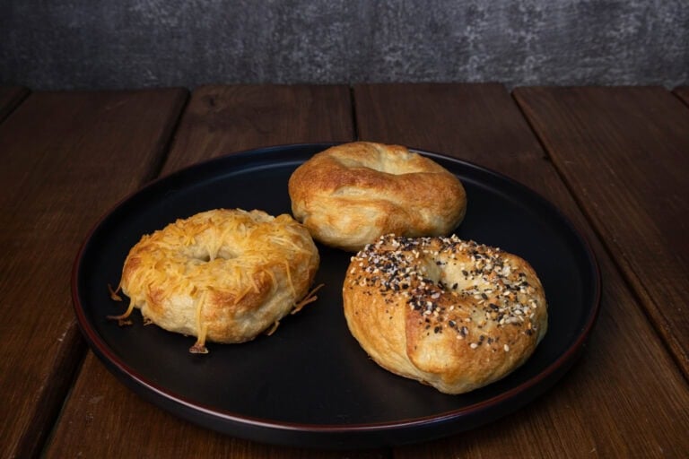 Plate with three high protein bagels - toasted parmesan, everything and plain.