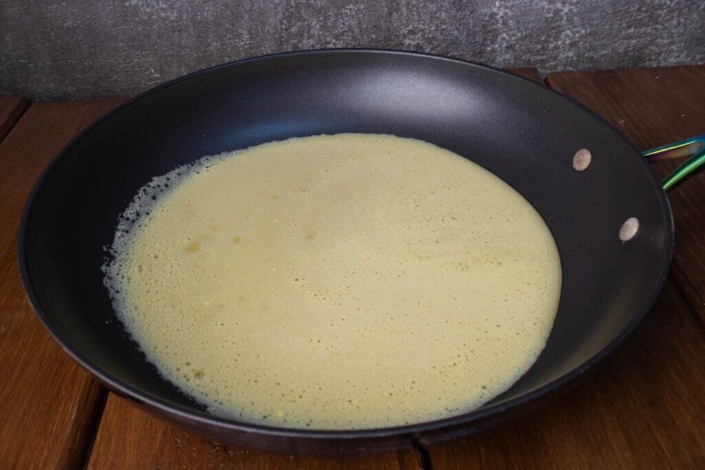 Uncooked vegan liquid egg in a pan.