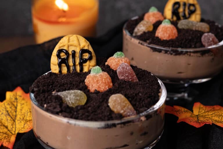 Dirt Pudding in little pudding glasses on a Fall decorated table.