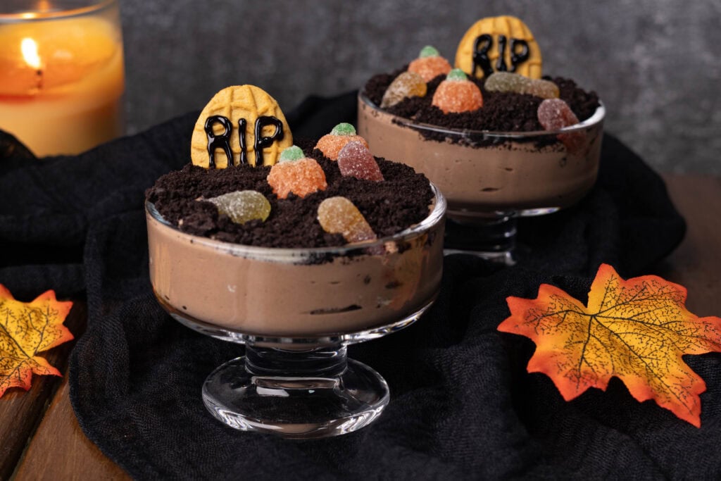 Dirt Pudding in little pudding glasses on a Fall decorated table.