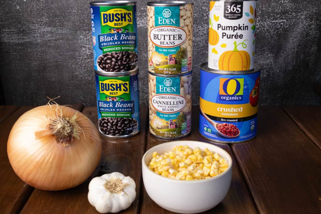 Chili ingredients - onion, garlic, corn, black beans, butter beans, white kidney beans, crushed fire roasted tomatoes and pumpkin puree.