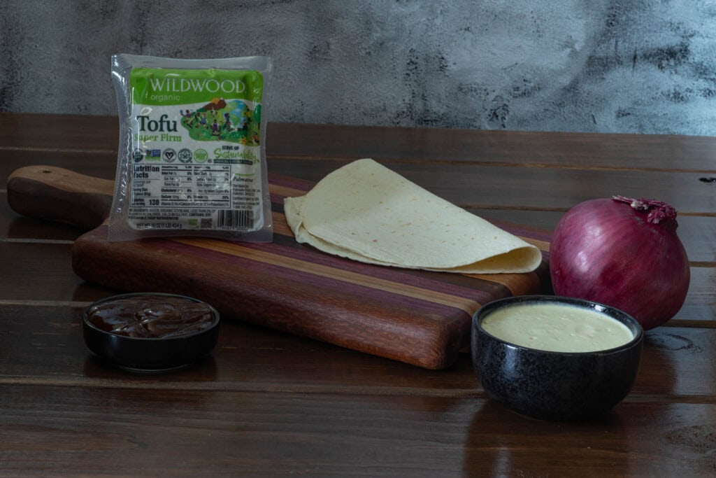 Tofu, BBQ Sauce, vegan cashew queso and red onion.