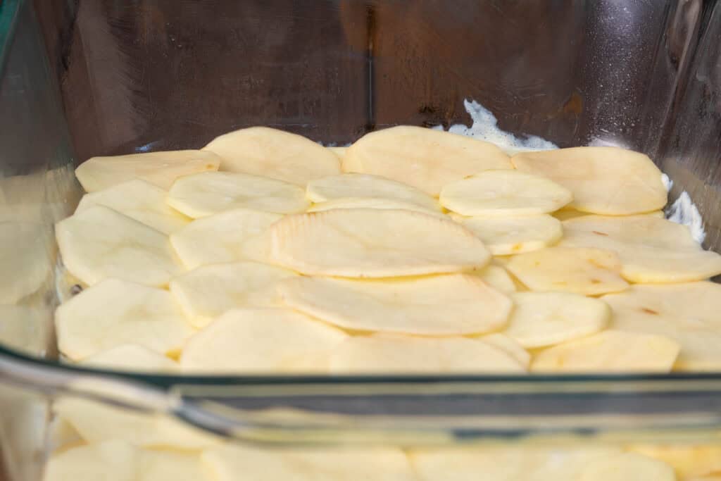 Bacon scalloped potatoes - the potato layer.