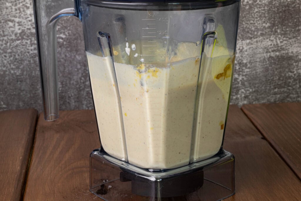 Blender with blended silken tofu, garlic, onion and spices.