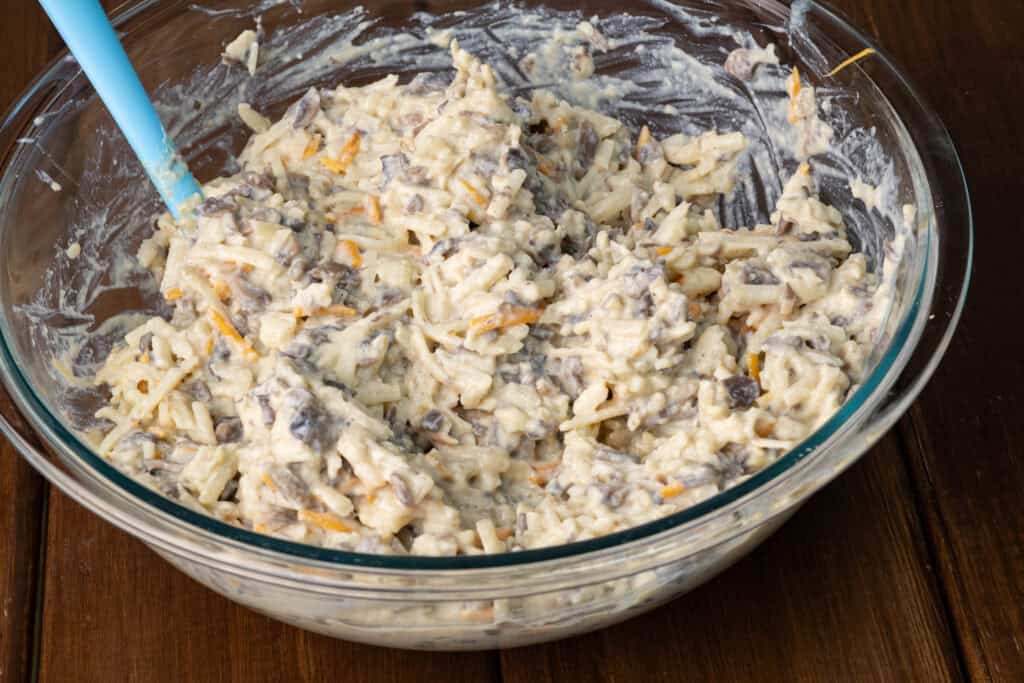 Mixed up hashbrown casserole in a big bowl.