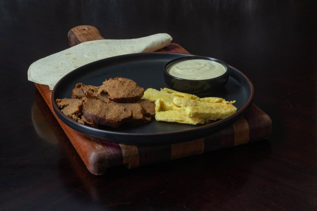 Tortillas, seasoned seitan steak, Just egg, and vegan cashew queso.