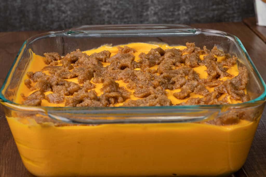 Sweet potato casserole with brown sugar topping before cooing in the oven.