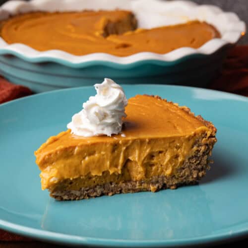 Plate of sweet potato pie with a dollop of vegan whipped cream.