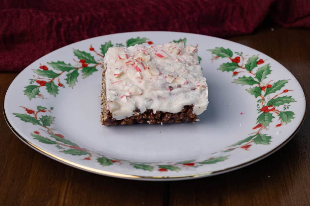Chocolate rice crispy treats with a white chocolate topping and sprinkling of crushed candy canes.