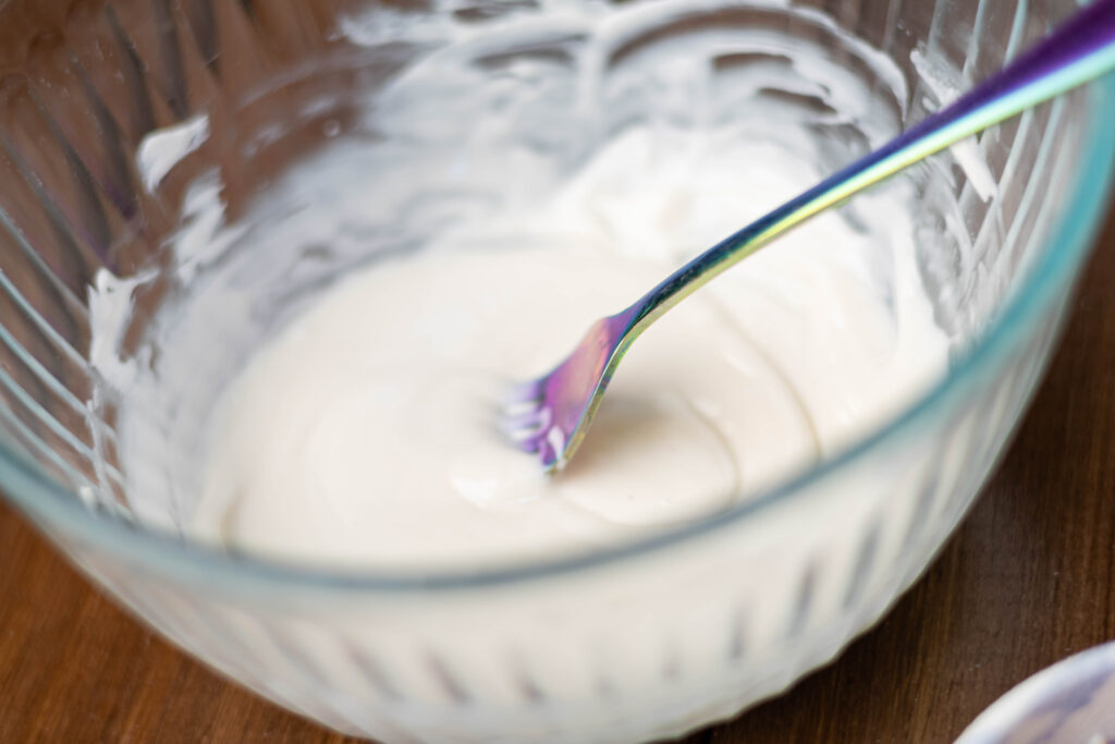 Melted white chocolate in a bowl.