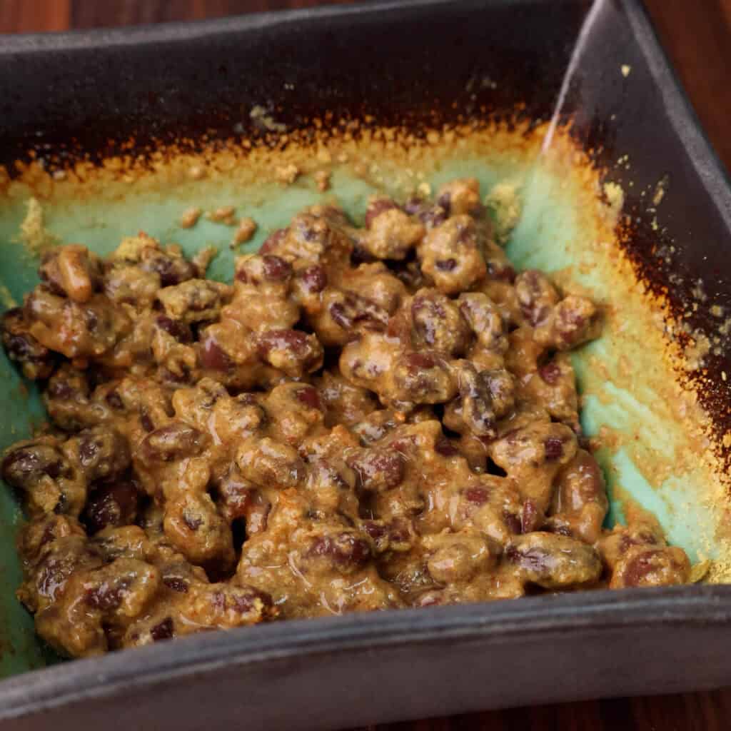 Cheesy black beans in a bowl.
