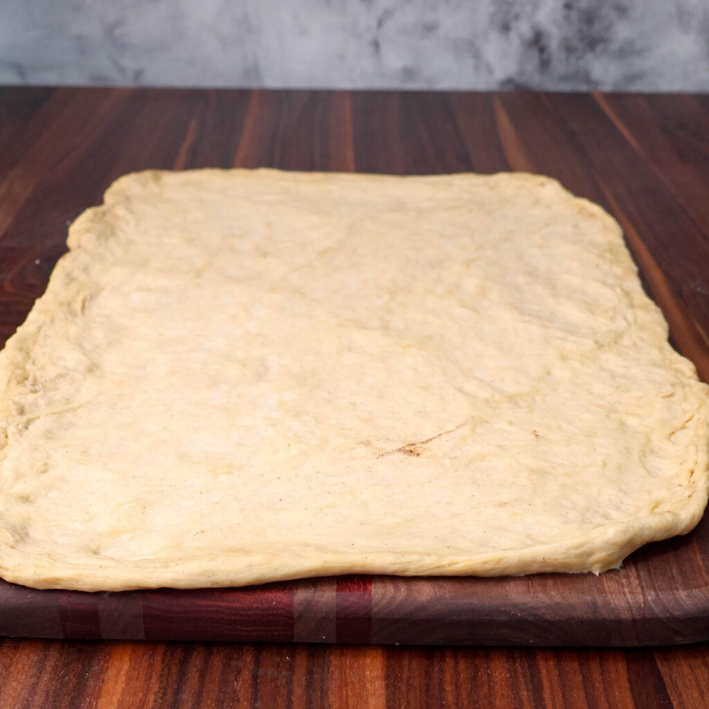 Cinnamon roll dough rolled out.