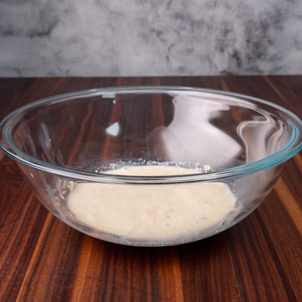 Mix, sugar and yeast in a bowl.