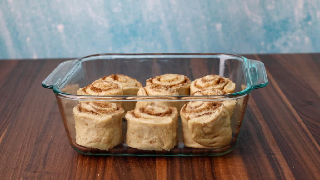 Cinnamon rolls unbaked in a baking dish.